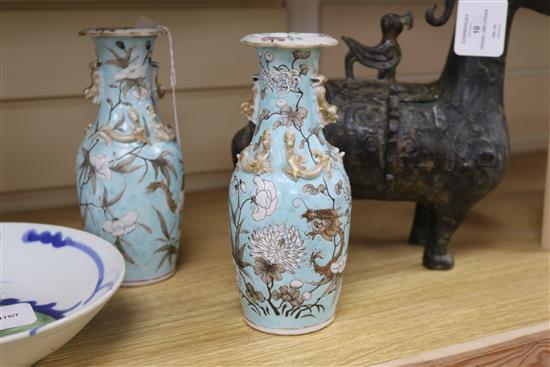 A pair of Chinese vases decorated dragons and foliage in white and brown on a pale turquoise ground and a provincial dish